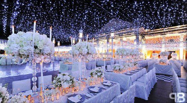 how-to-create-a-winter-wonderland-wedding-reception-decor-planning-high-floral-topiaries-blue-lighting.full