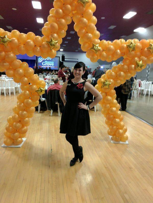 Fairy Godmother Cassandra in front of the Paradise Balloon Designs balloon arch at the Shannon Grove for Senate launch.